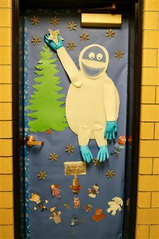 Large abominable snowman putting star on pine tree and picture of mini misfits