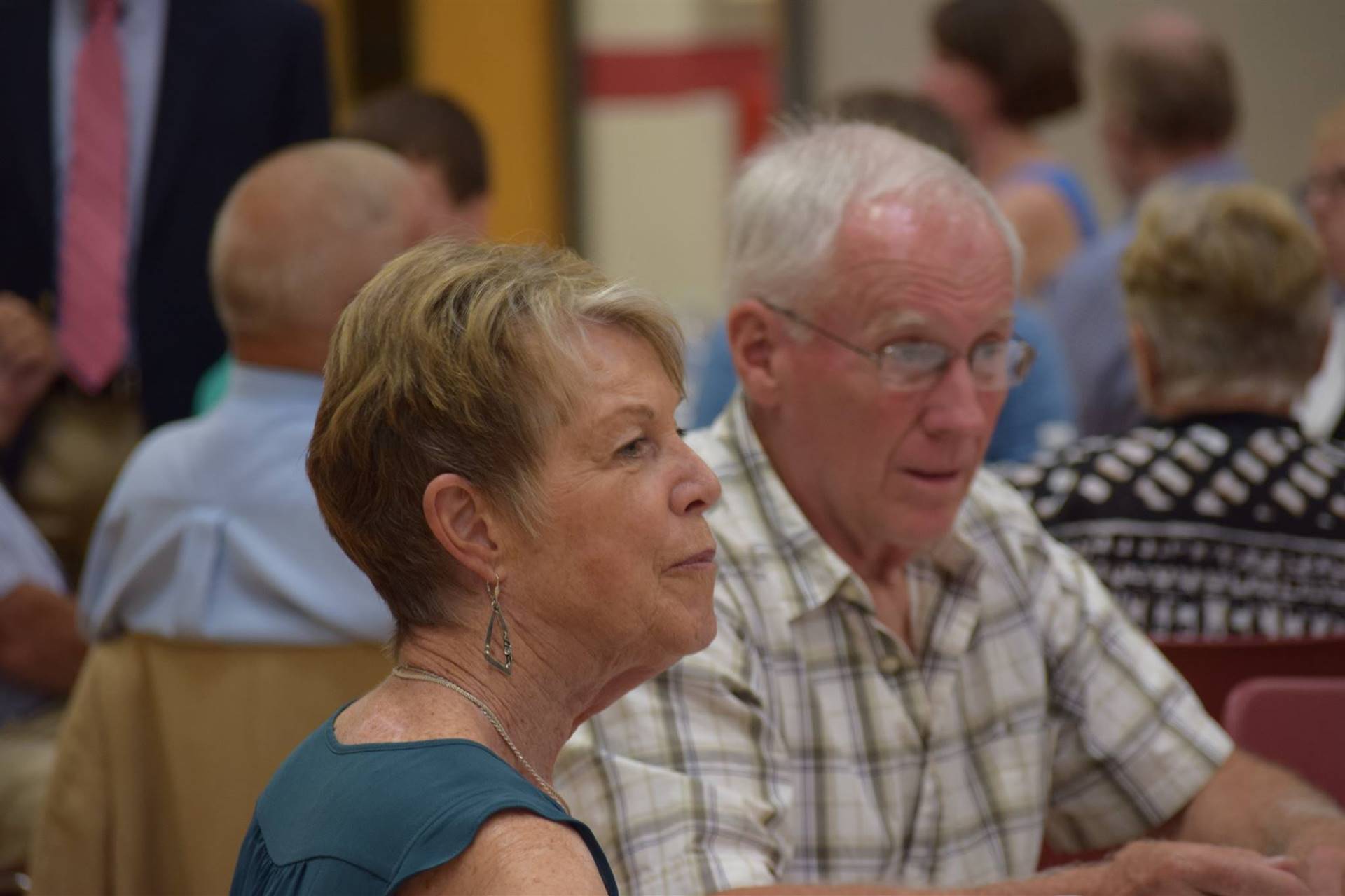 Honoree Mr. Emerson and his wife sitting at dinner ceremony.