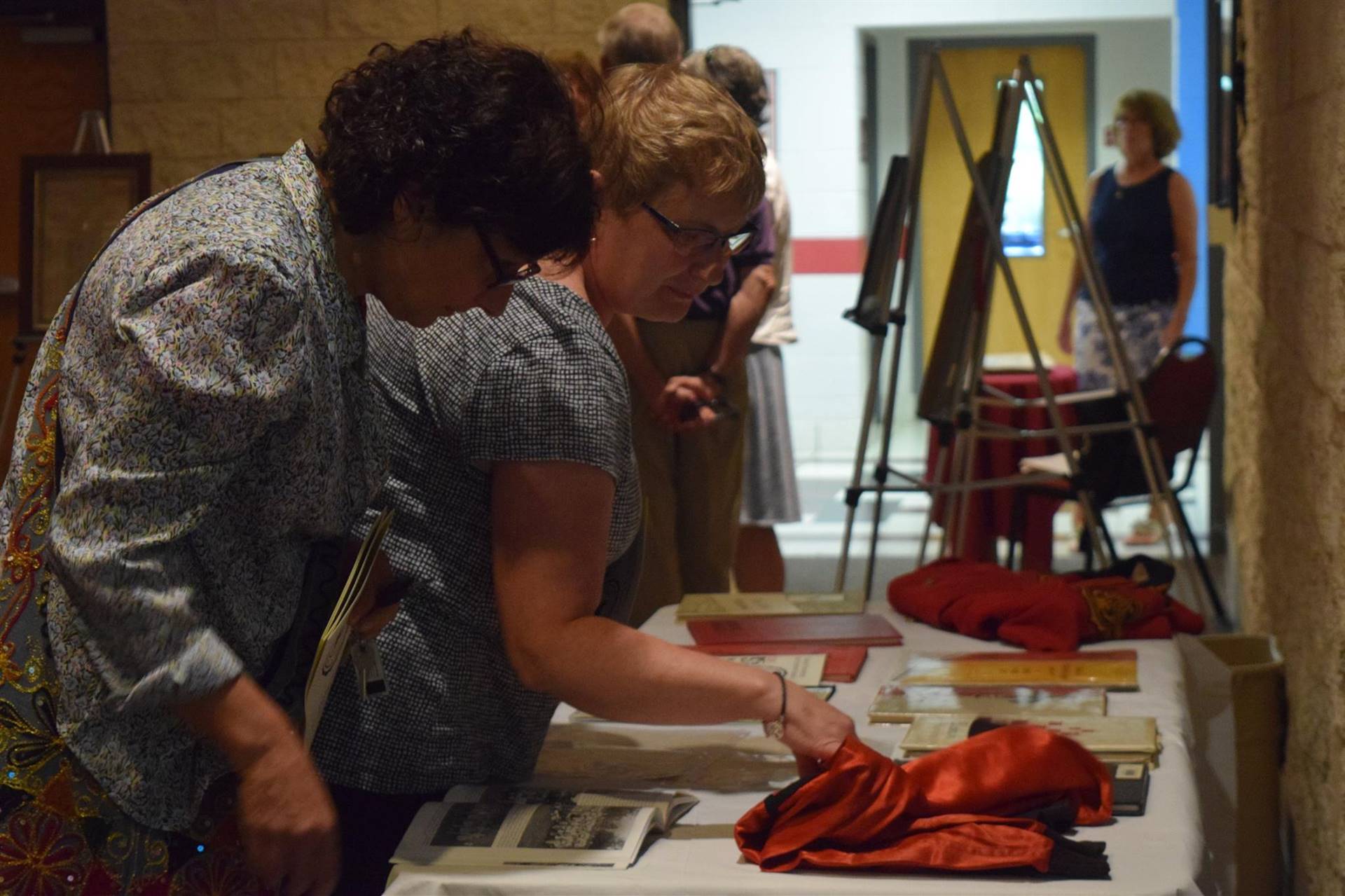 Attendees admiring the display of historical artifacts at the ceremony.