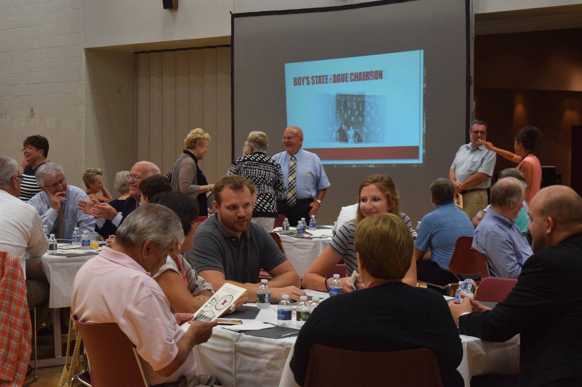 Attendees sitting at tables eating dinner.