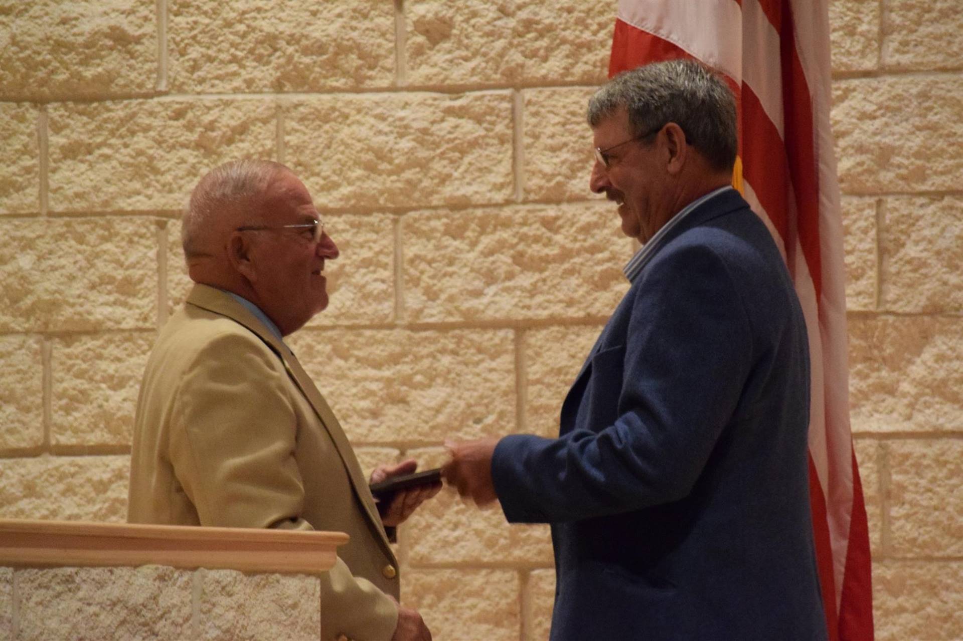 Honoree Mr. Marshman receiving a plaque from Mr. Weidman.
