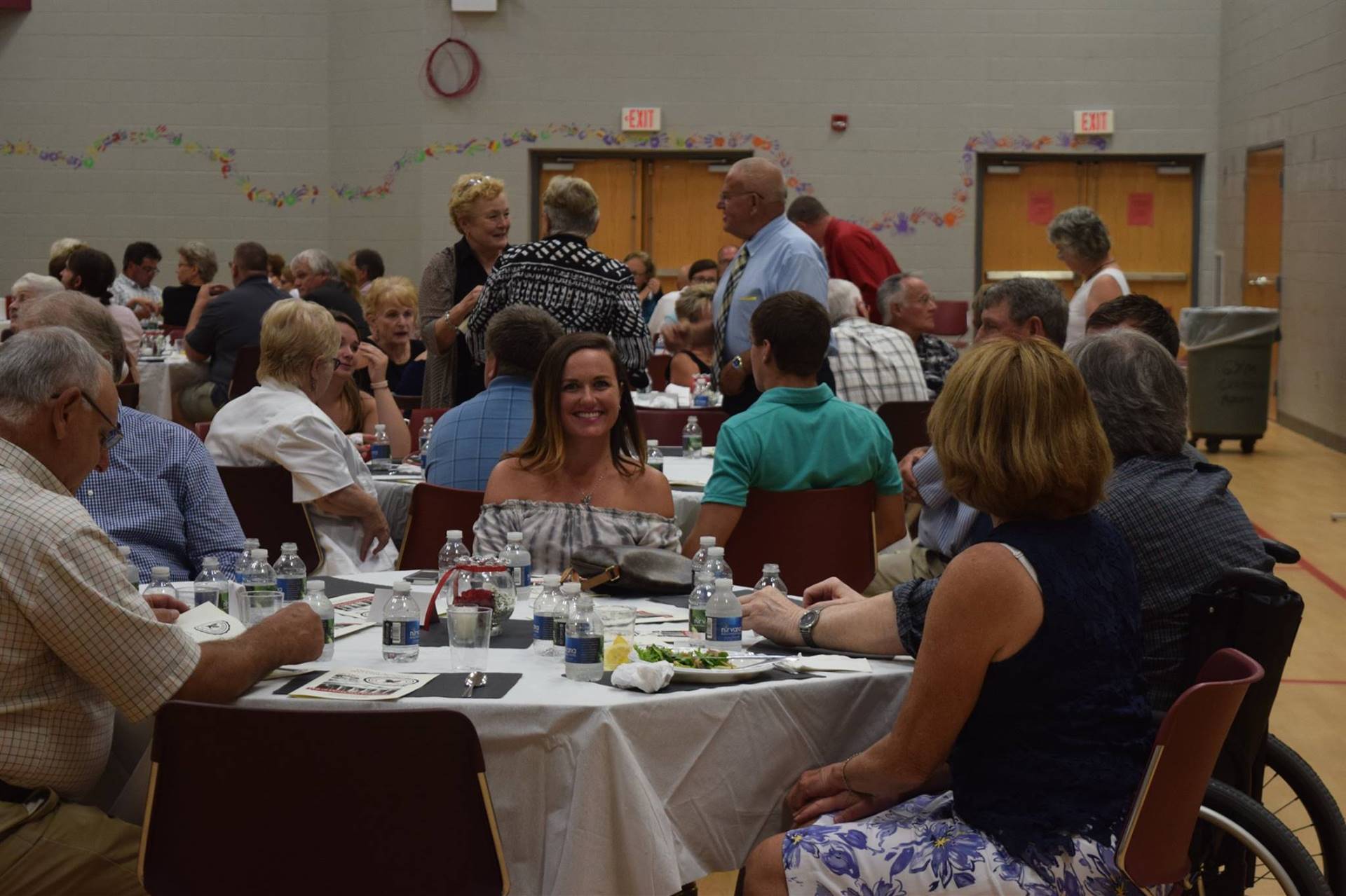 Attendees sitting at tables eating dinner.