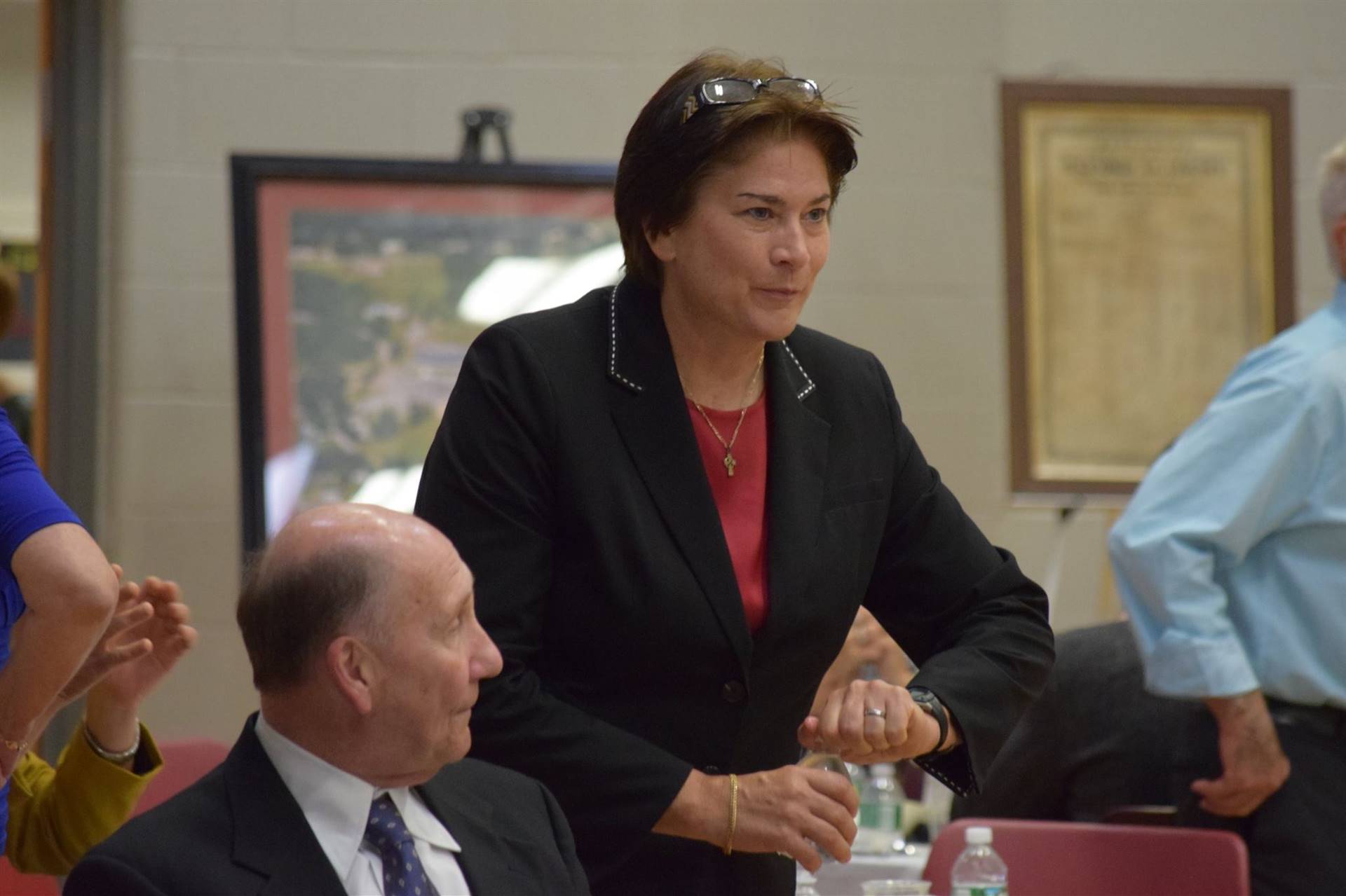 Woman talking to honoree during ceremony.