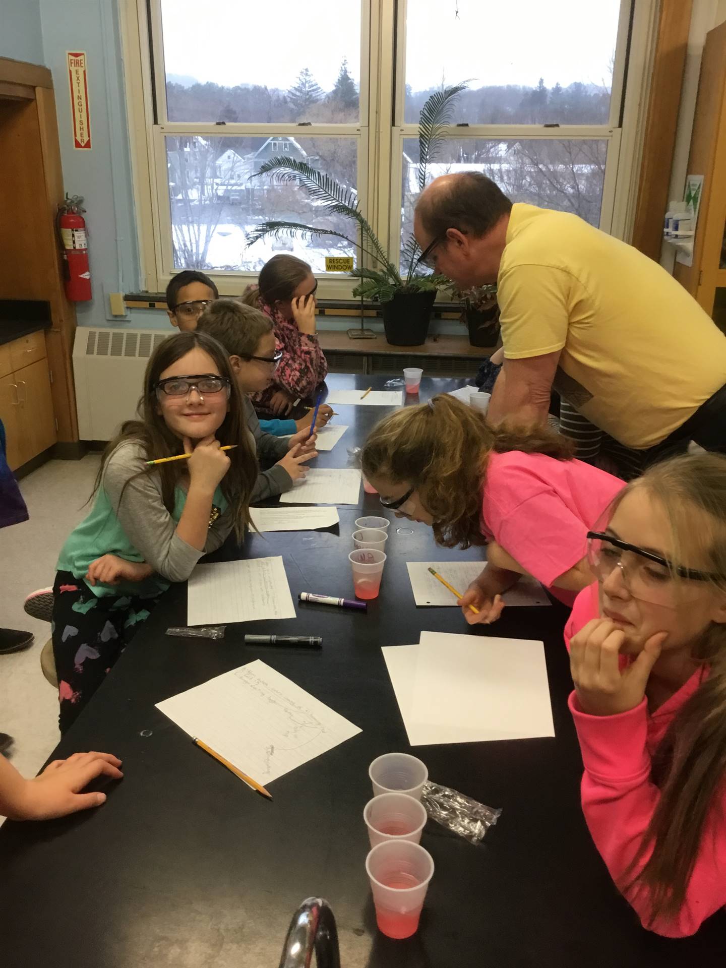 Mr. Champlin helps students with candy cane experiment