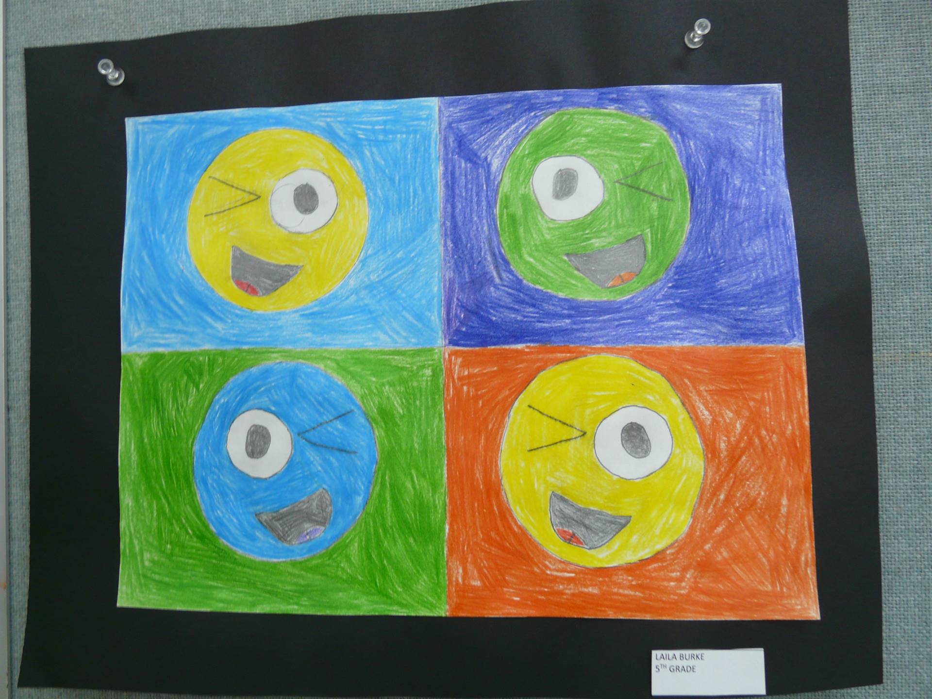 4 smiley faces in boxes-  all different colors with winking eyes