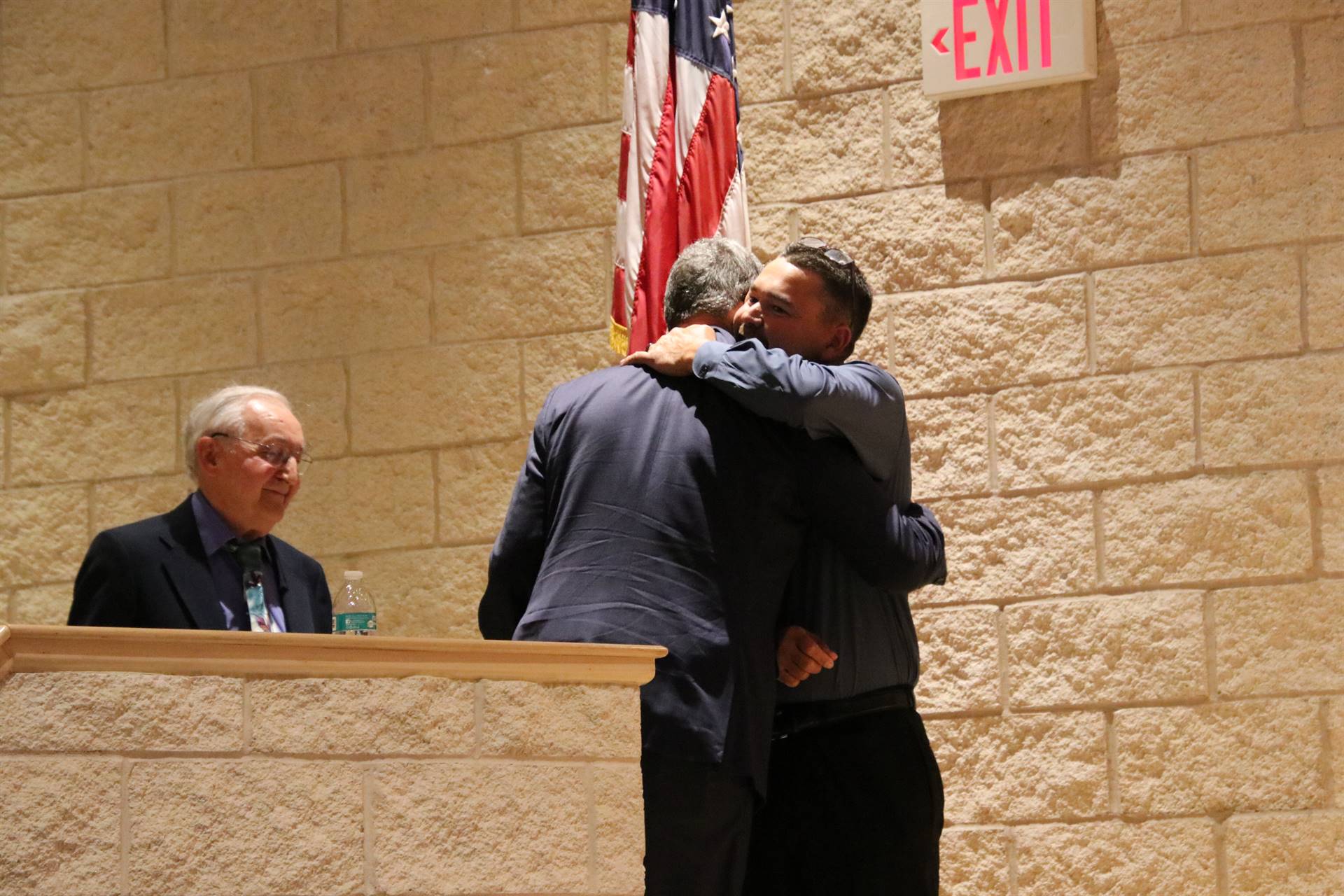 Mr. Johnson receiving his award with a hug from Mr. Spencer