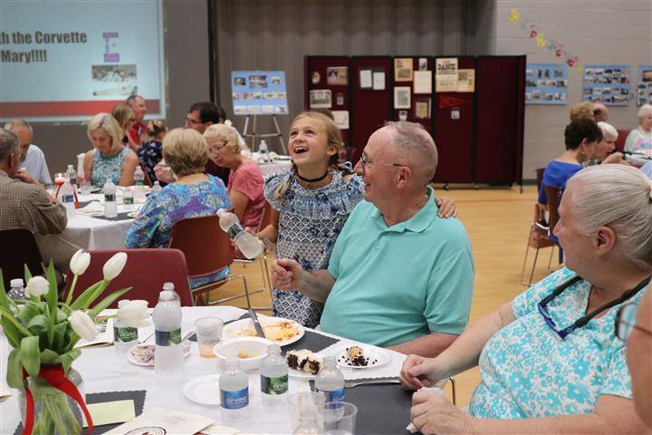 Attendees laughing after dinner