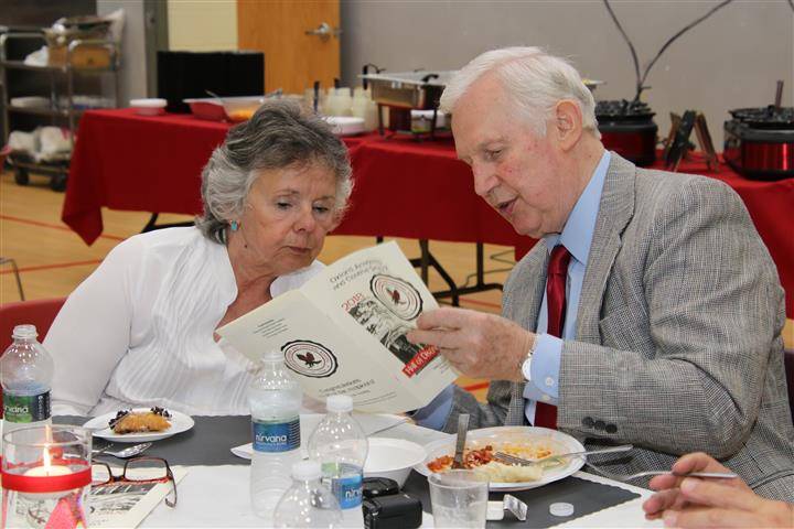 two attendees looking at brochure