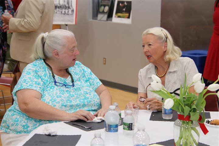 two attendees chatting