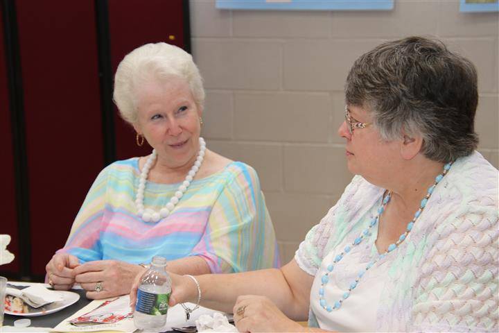 two attendees chatting