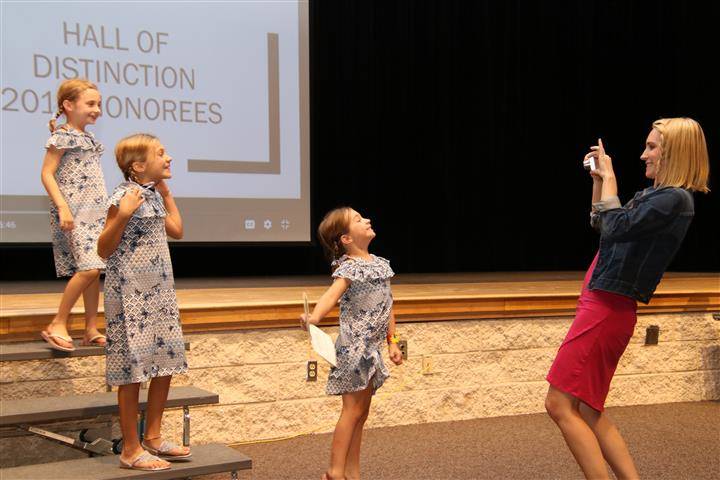 honoree&#39;s girls on stage posing for a picture