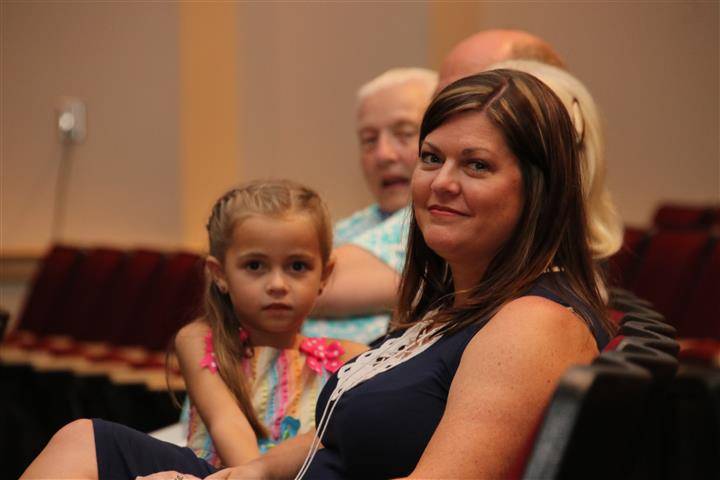 honoree&#39;s wife and daughter posing for a picture