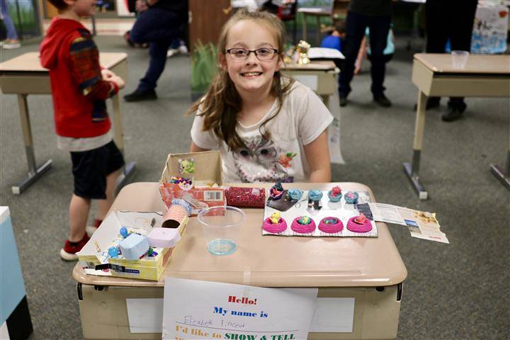 student sitting with display