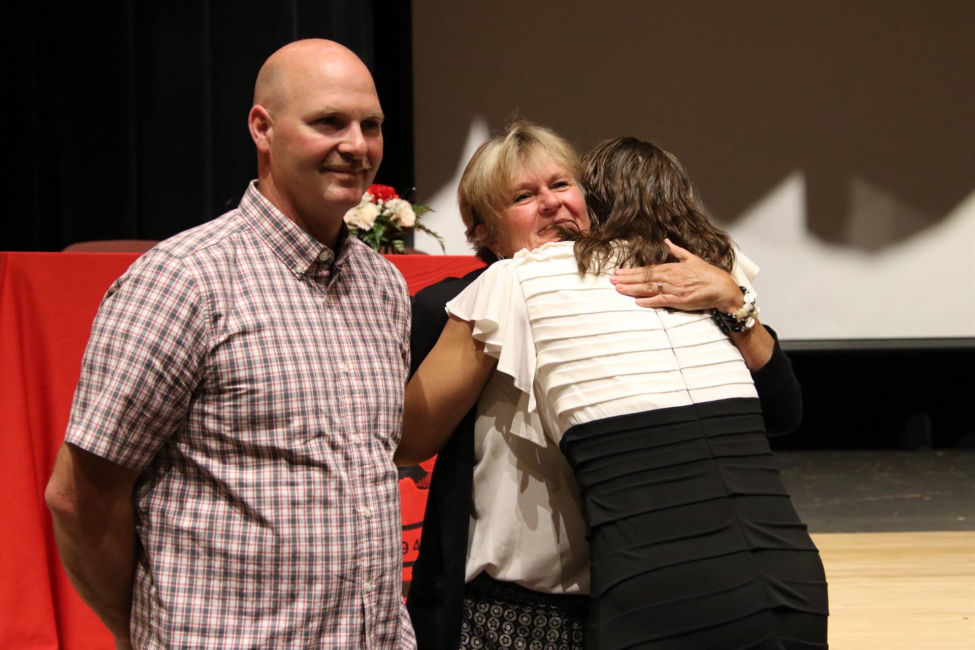 Hall of Distinction honoree hugging attendee