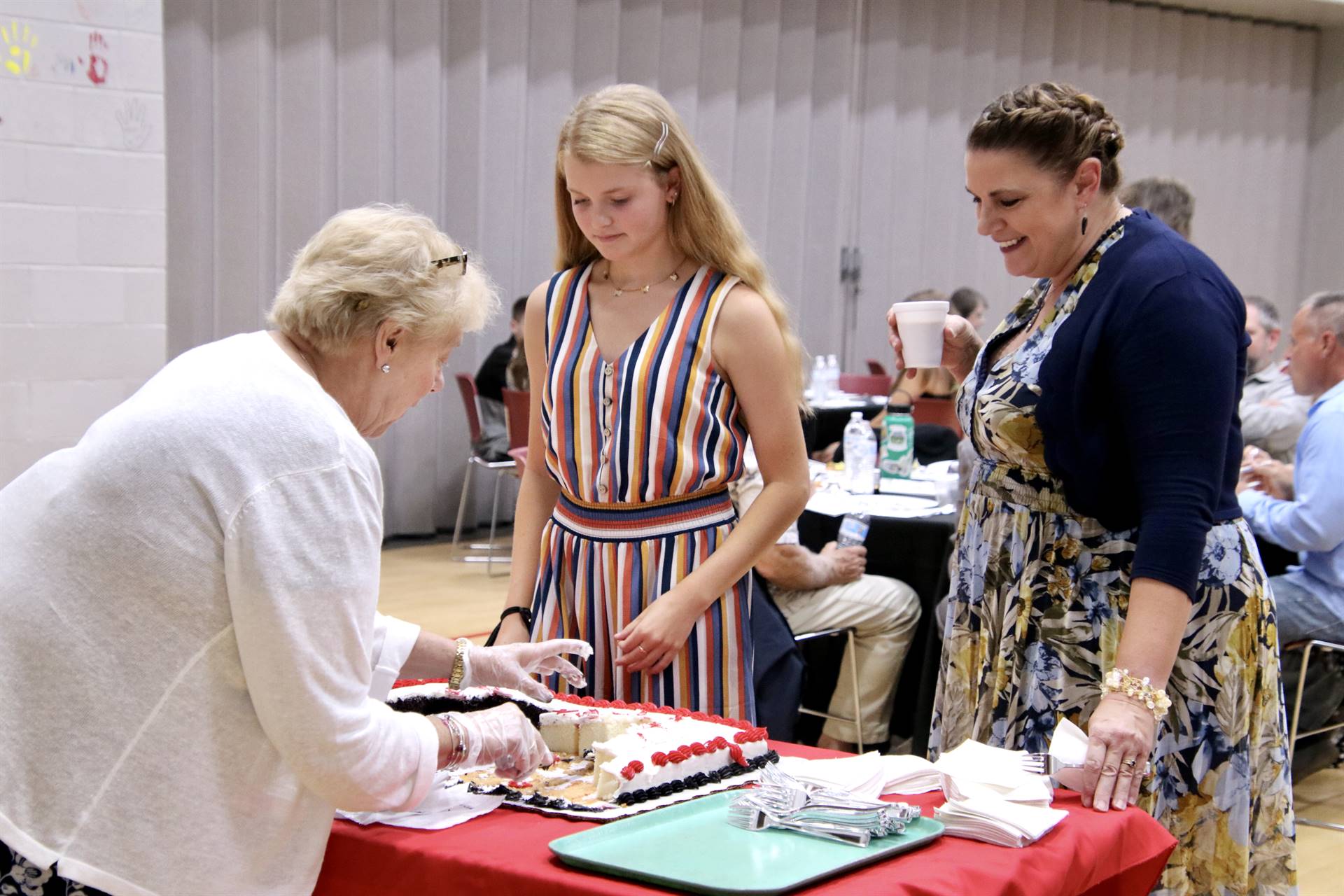 Hall of Distinction attendees getting cake