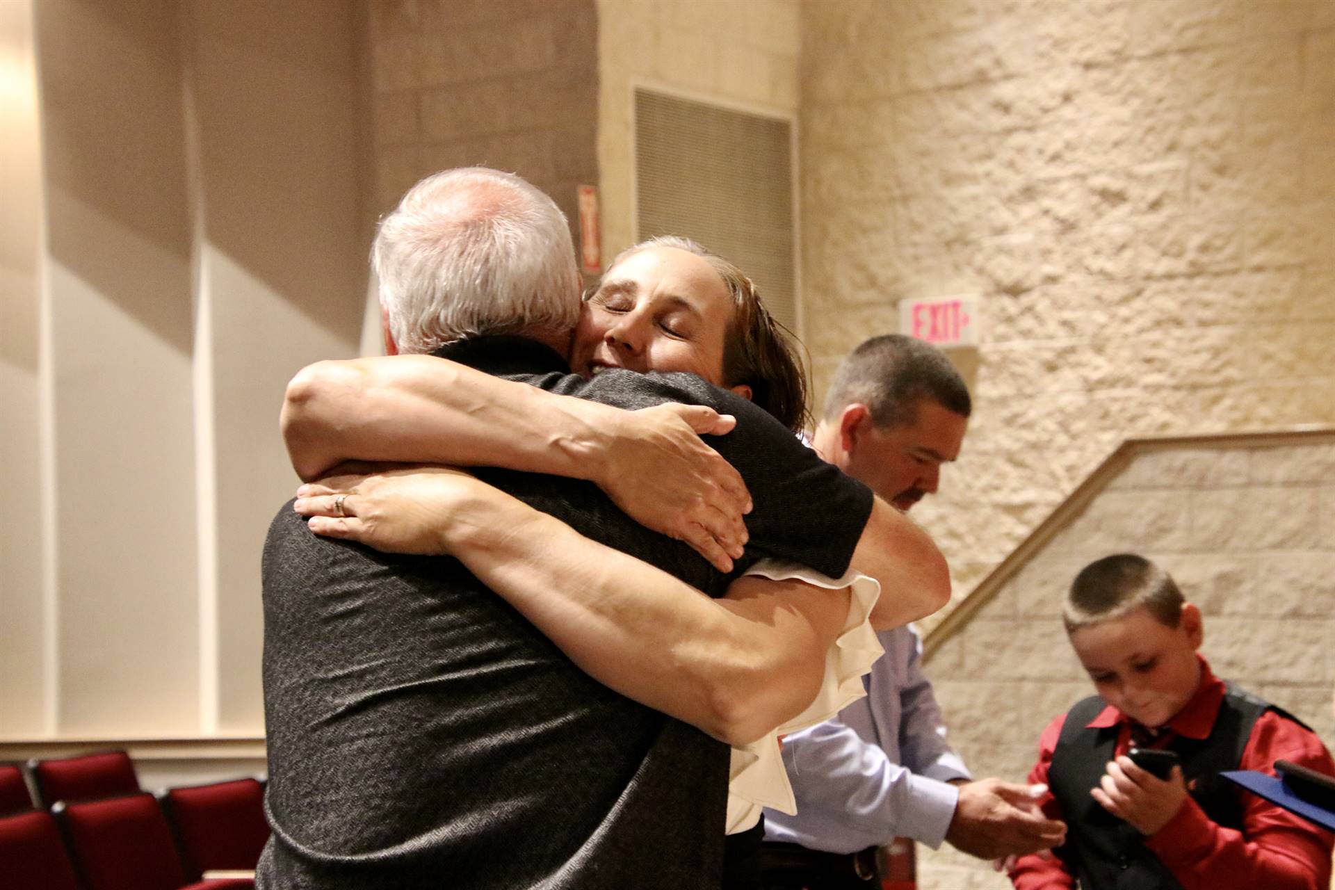 Hall of Distinction honoree Barrows hugging presenter Carey