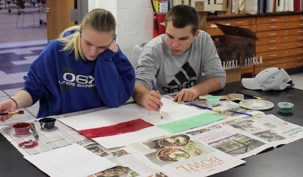 Two students working on Clyde Cole school posters