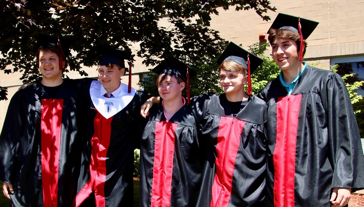 Graduates posing outside