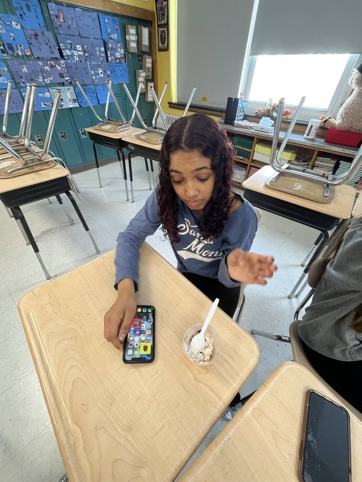 girl eating ice cream on her phone 