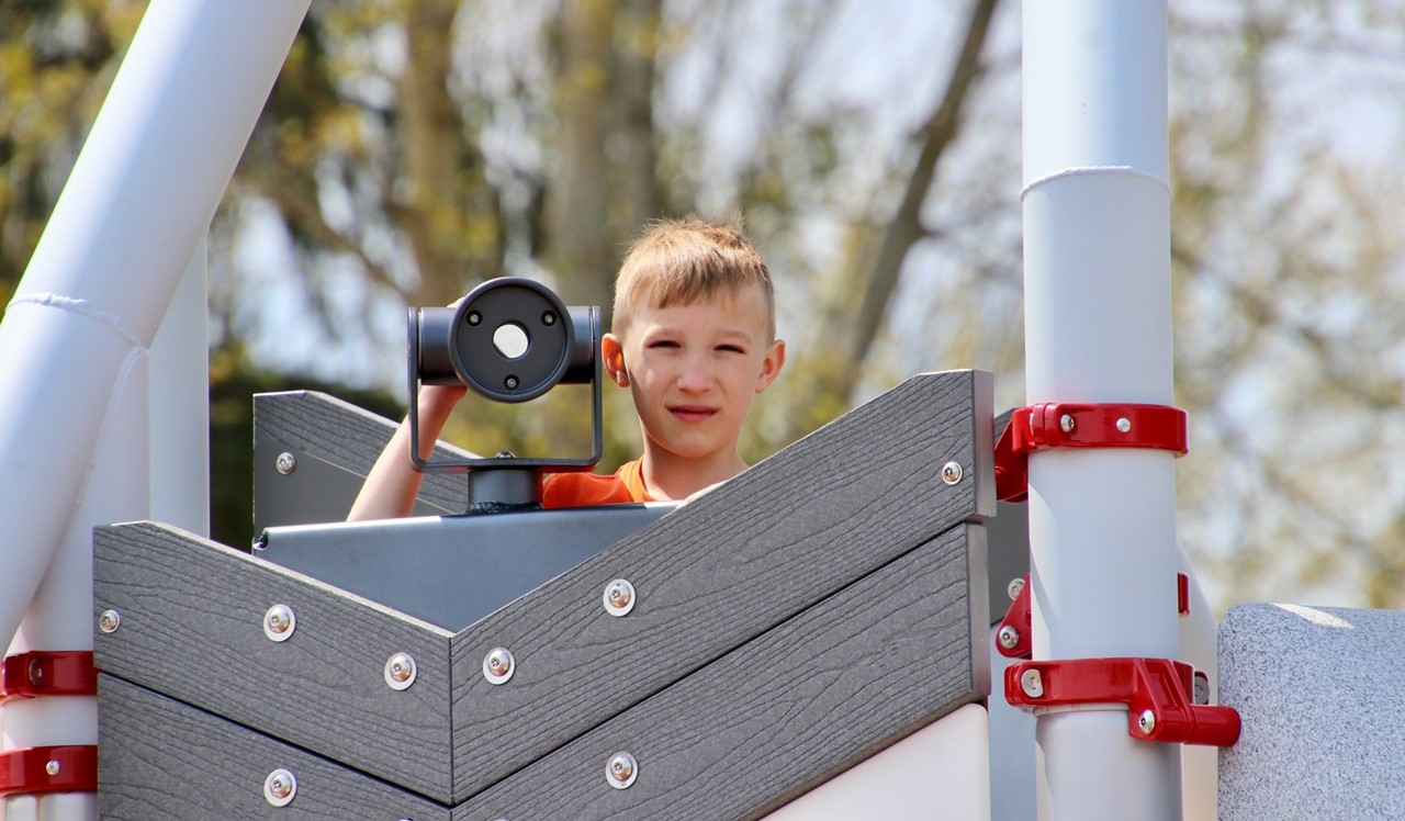 boy on playground near scope