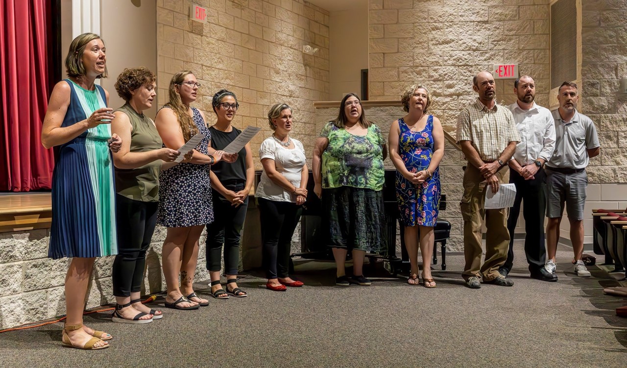 Group singing the Alma Mater