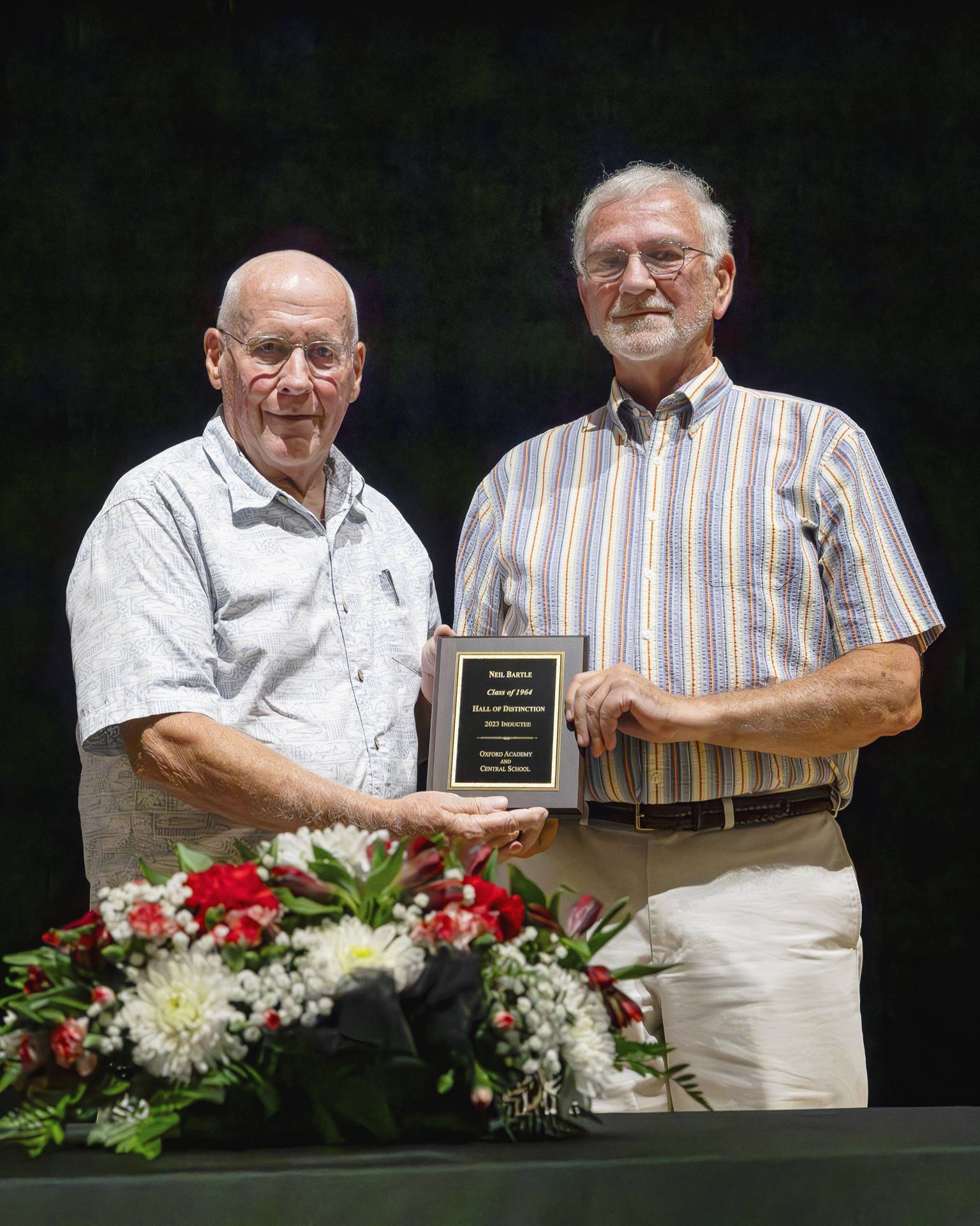 Mr. Emerson and inductee Neil Bartle holding plaque