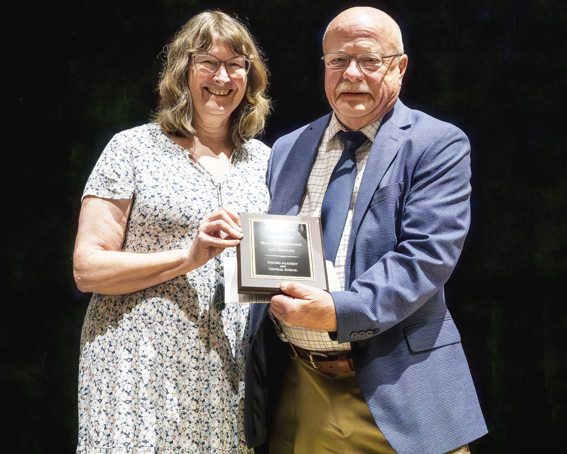 Claudia Griffin with inductee Wilcox holding plaque